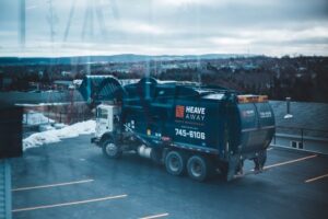 A garbage truck in a parking lot