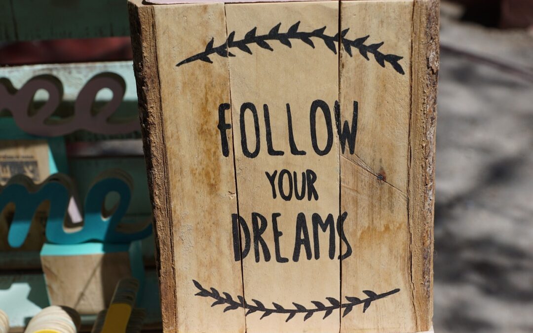 Follow Your Dreams logo on a wood