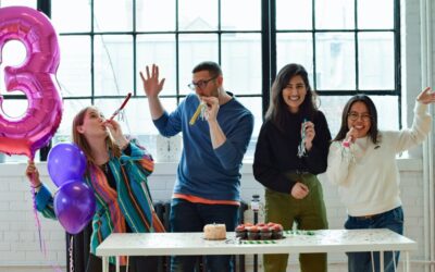 A group of people celebrating with a cake